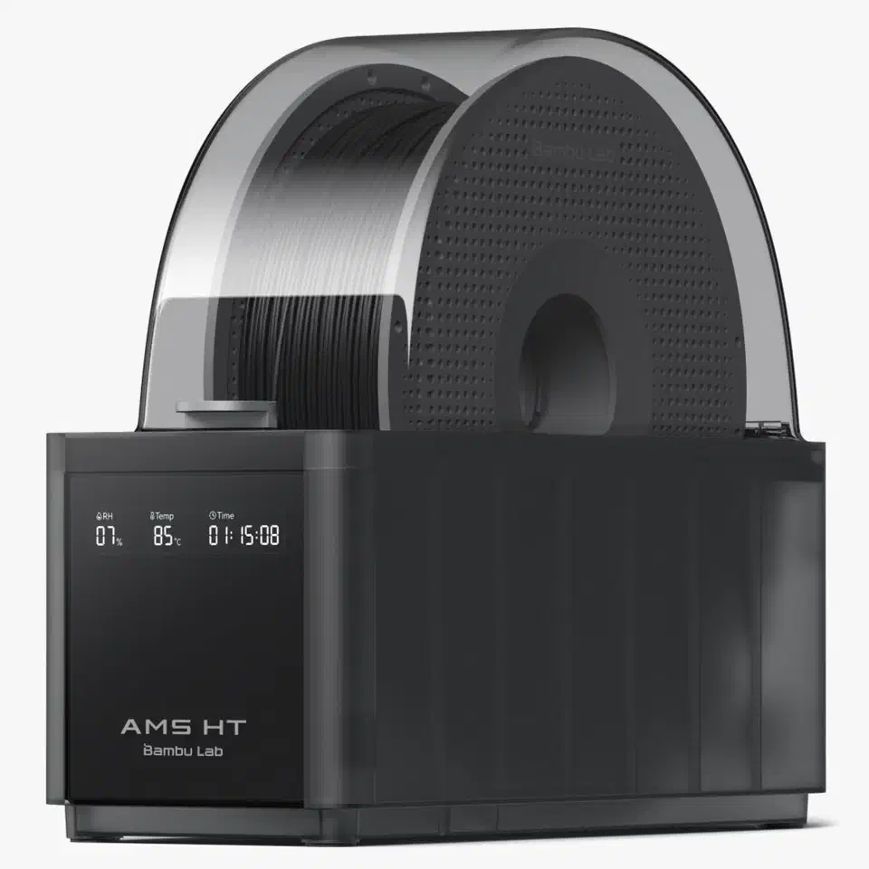 Bambu Lab AMS HT single-spool dryer with a black filament spool under a clear dome, front display reading 85°C