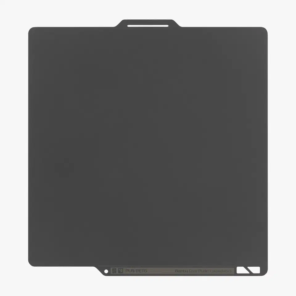 Dark grey Bambu Cool Plate SuperTack spring steel sheet with a top pull tab and a PLA/PETG label strip along the bottom edge