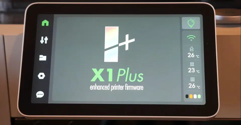 X1Plus custom firmware home screen on a Bambu Lab X1 printer touchscreen, showing the X1Plus logo, a sidebar of icons and live nozzle, bed and chamber temperatures of 26, 23 and 26 degrees