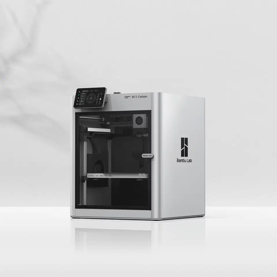 Bambu Lab X1 Carbon 3D printer, a white enclosed cube machine with a glass door and a touchscreen control panel mounted on the front left corner