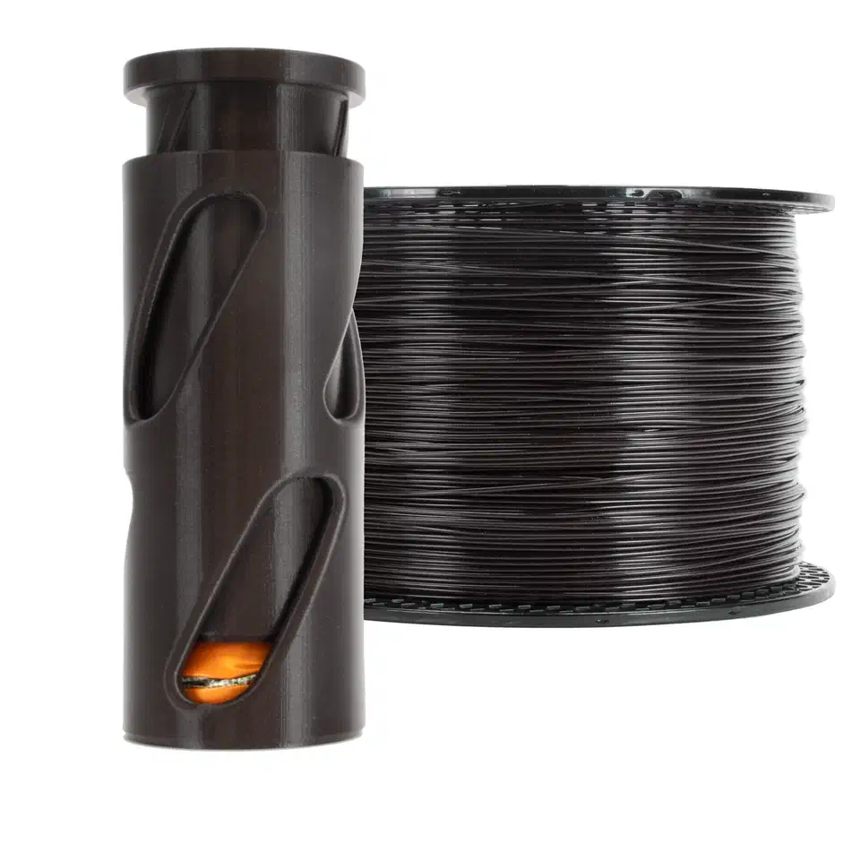 Dark brown recycled Prusament PETG spool beside its cylindrical recycled packaging tube, showing the unpredictable batch color