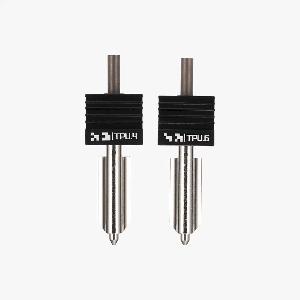 Two Bambu hardened steel high-flow hotend nozzles labelled TPU.4 and TPU.6 standing side by side on a light background