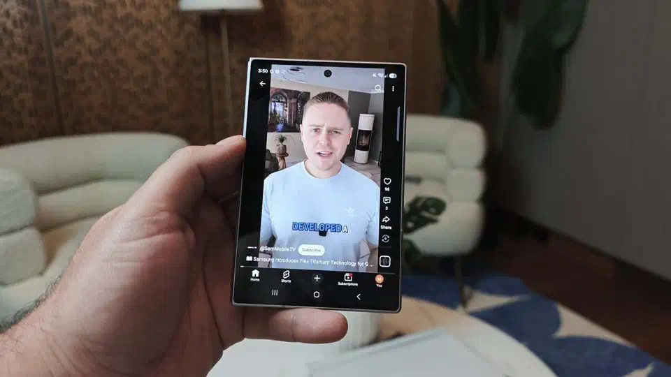 Closed Galaxy Z Fold 8 held in one hand playing a video on its short wide 5.5-inch cover screen