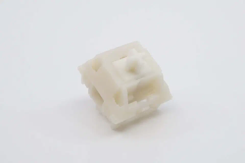 Gazzew Boba U4 switch with a color-matched milky Pearl top housing and cross stem on a white background