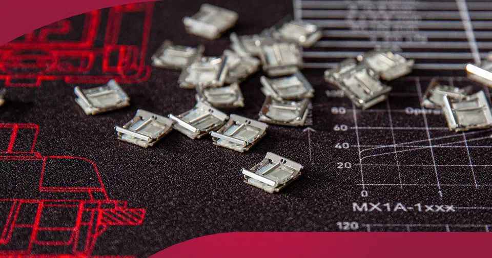A scattered handful of tiny metal Cherry MX Ultra Low Profile surface-mount switches on a dark technical background printed with a force-travel graph