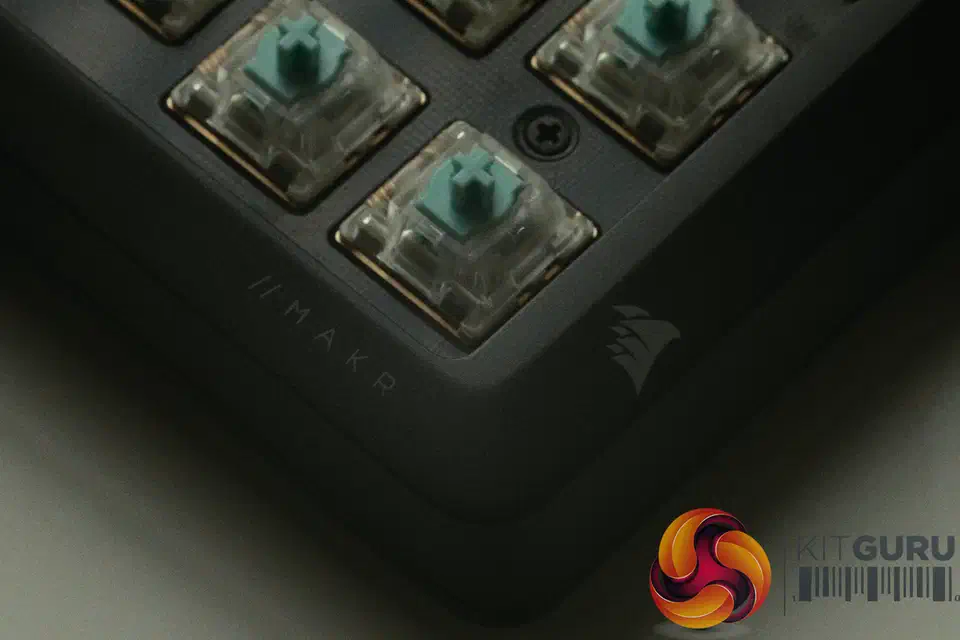 Close-up of the exposed teal Corsair MGX V2 Hall Effect switches on the Makr Pro 75 plate, with a mounting screw and the MAKR logo visible
