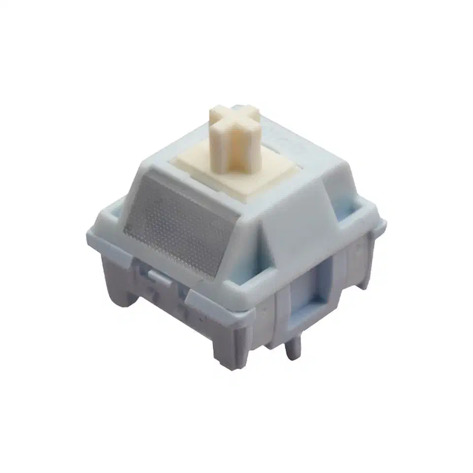A single HMX Yogurt S linear switch with a pale blue-grey housing, cream cross-shaped stem and a silver textured top pad, on a white background