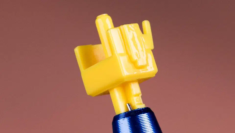 Yellow Gateron Milky Yellow Pro stem on a blue stem holder showing a thin glossy lube film across the rails