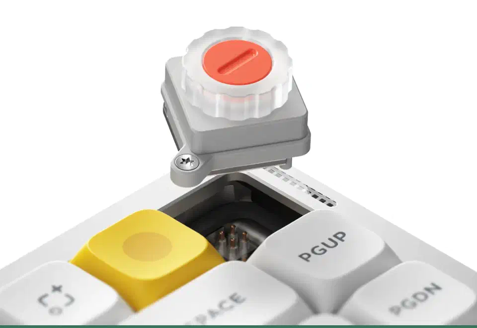 NuPhy Air75 V3 rotary knob module lifted out of its top-right socket, exposing the hot-swap switch pins beneath