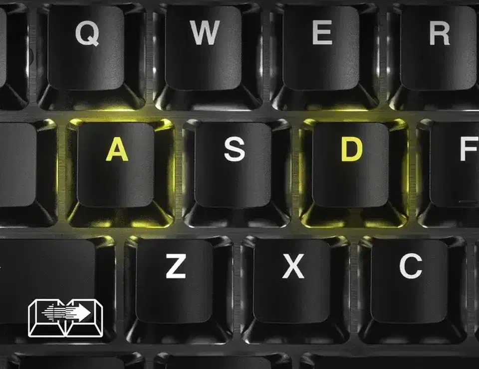 Close-up of a keyboard with the A and D keycaps lit yellow while the surrounding keys stay unlit