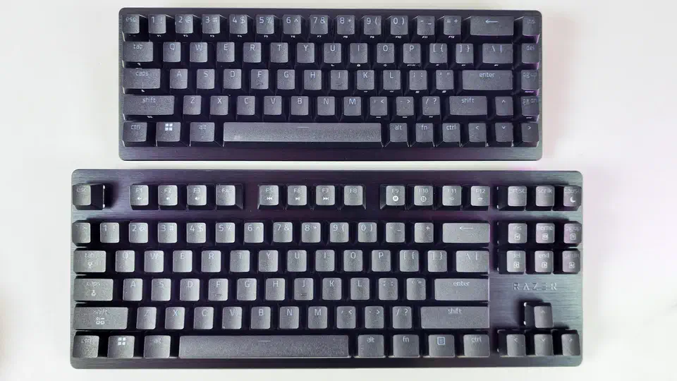 Top-down comparison of the Mini 65% and the TKL on a white desk