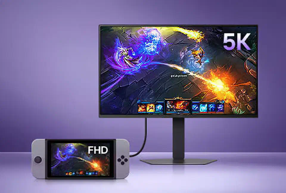 Handheld console running a game at FHD connected by cable to an UltraGear evo monitor showing the same game labelled 5K