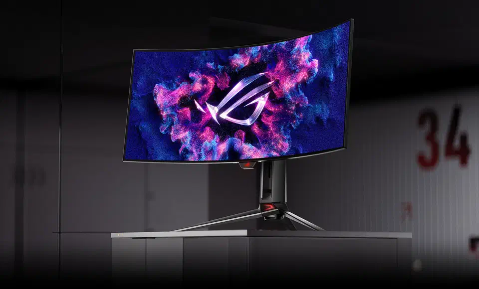 Asus ROG Swift PG34WCDM 34-inch curved ultrawide OLED monitor on its central stand with the ROG logo glowing on screen