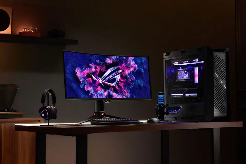 Asus ROG Swift PG34WCDN curved ultrawide gaming monitor on a desk showing a game scene