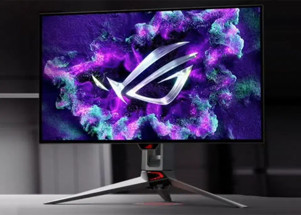 Asus ROG Swift PG27AQDP OLED gaming monitor on a stand displaying a purple ROG cloud graphic