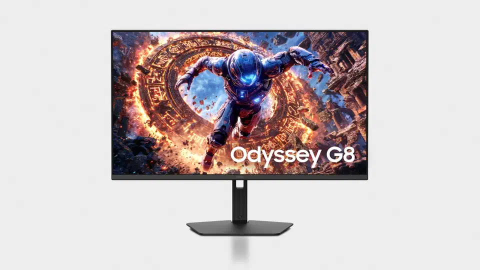 Samsung Odyssey G8 G80HS monitor viewed head on, black bezel and matching black stand, screen showing an armoured game character