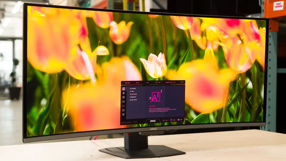 Curved MSI MPG 341CQR QD-OLED X36 ultrawide on a desk, showing yellow tulips with the AI settings menu open