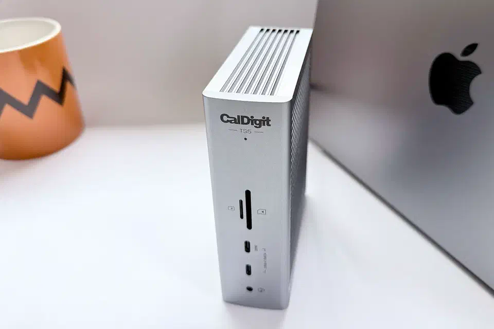 CalDigit TS5 Thunderbolt 5 dock, a compact dark grey slab with Thunderbolt, USB and Ethernet ports on its rear panel