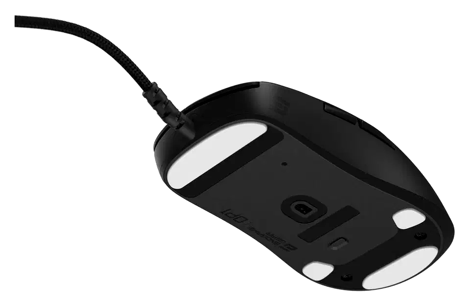 Underside of the black Endgame Gear OP1 8K v2 wired mouse showing white PTFE skates, the optical sensor and a small DPI button below it