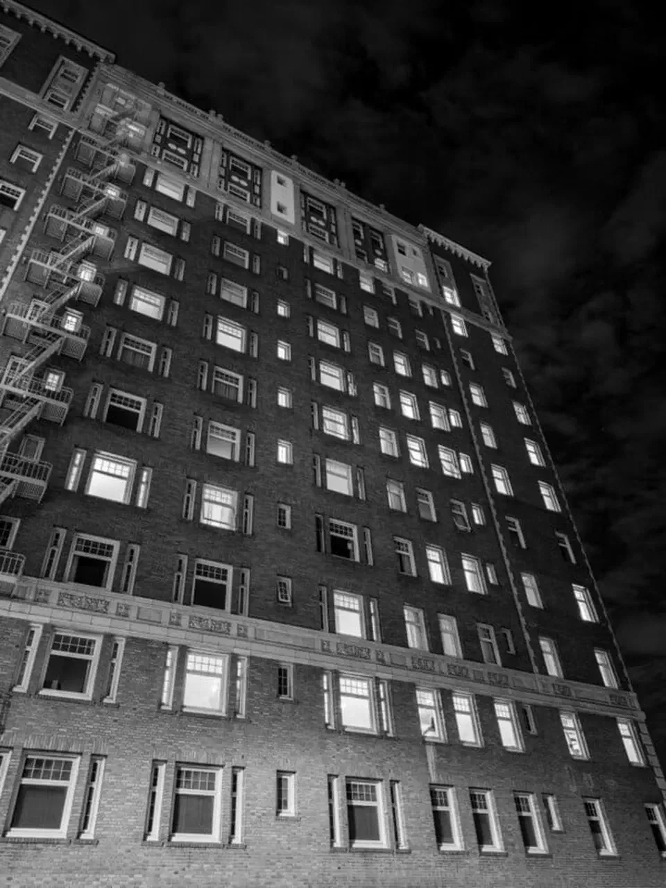 Black and white night photo of a brick apartment building shot on the Galaxy S26 Ultra main camera