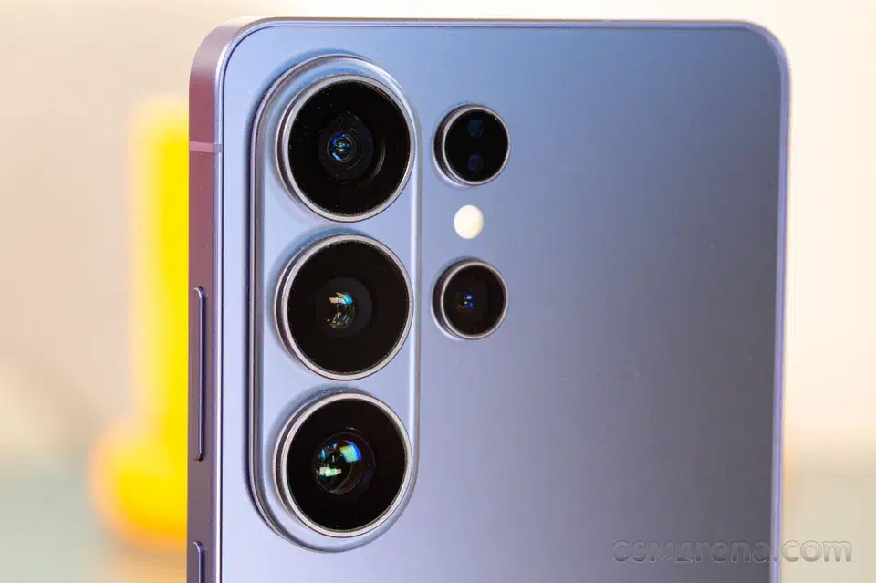 Close-up of the Galaxy S26 Ultra rear camera island, three large lenses stacked in raised metal rings beside two smaller sensors and the flash