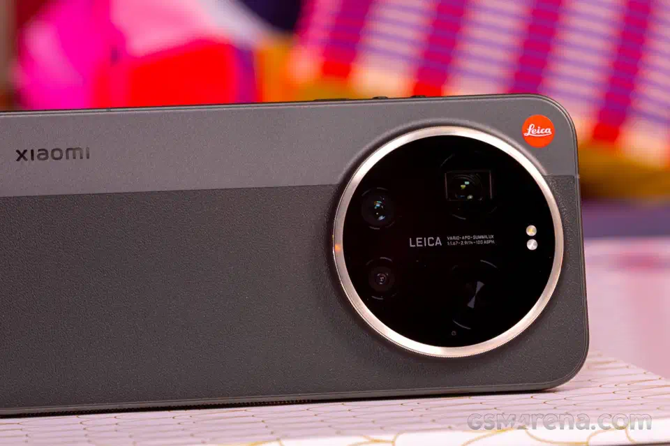 Close-up of the Leica edition camera island on a dual-tone grey back, showing the polished rotating ring, the red Leica badge and the LEICA VARIO-APO-SUMMILUX lens marking