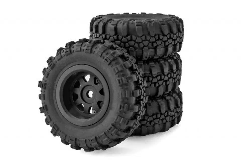 Four soft-compound rubber crawler tires stacked on one-piece black injection-molded wheels