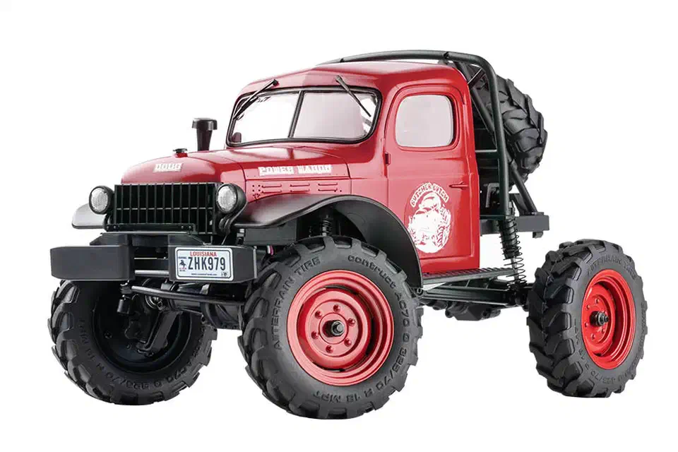 Red FMS FCX24S Power Wagon micro crawler with black grille, rear roll bar, spare tire and red beadlock wheels