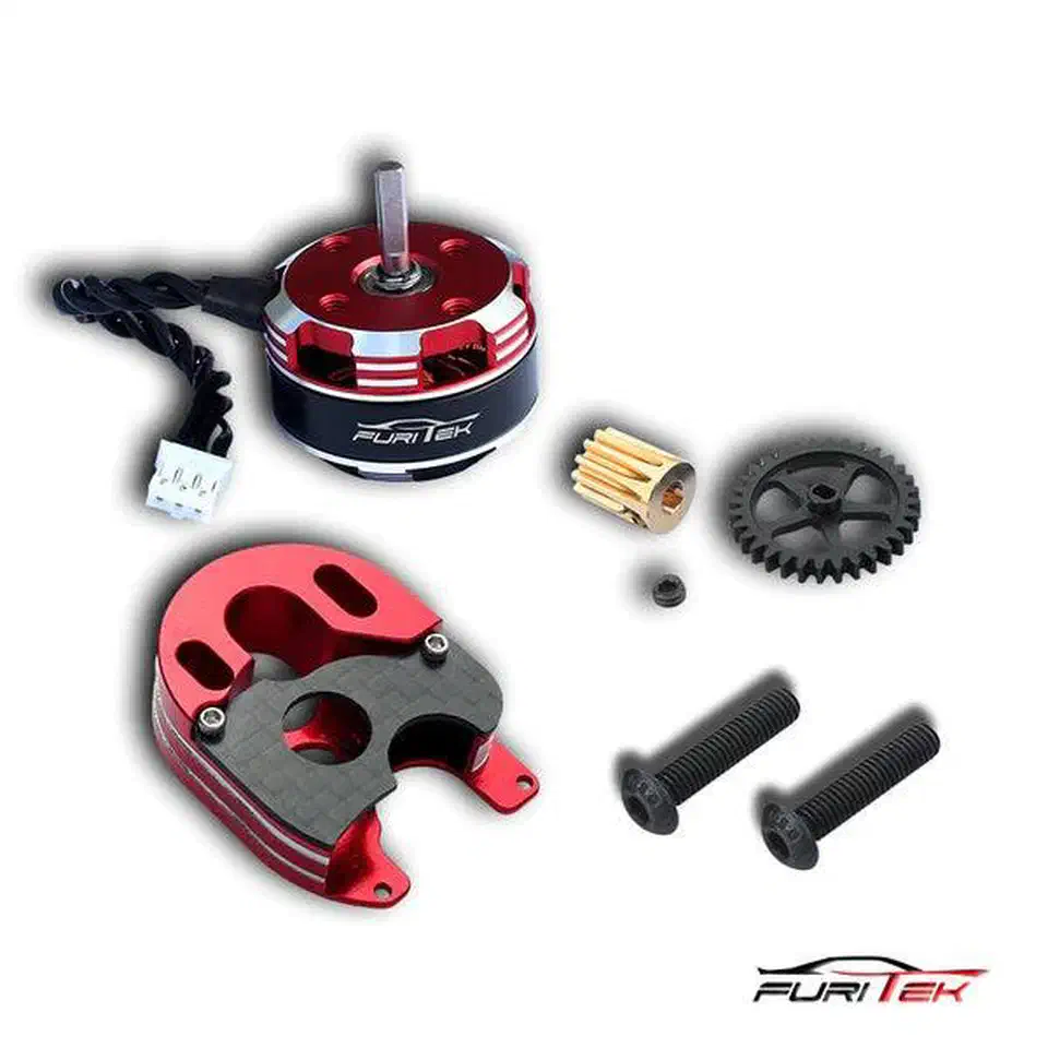 Furitek Komodo Ultimate Plus kit contents laid out: red and silver 2204 outrunner motor, red aluminum motor mount with carbon plate, brass pinion, black spur gear, and two mounting screws