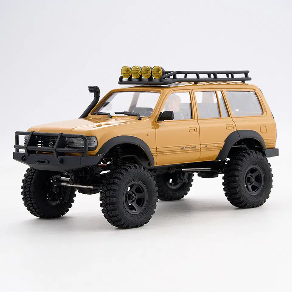 FMS FCX18 mini crawler with a tan Toyota Land Cruiser 80 hard body, snorkel, and roof-mounted spotlights