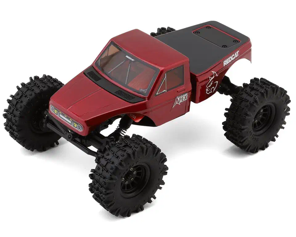 Red Redcat Ascent-18 Apex micro rock crawler with black roll cage and knobby off-road tires on beadlock wheels